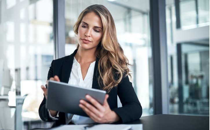 Businesswoman in an office building using a tablet.